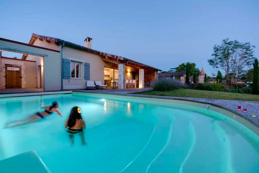 Outdoor swimming pool with terrace and sun loungers at a villa