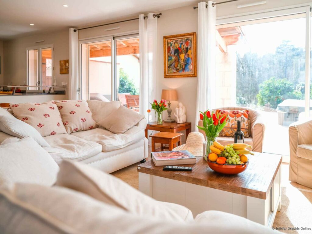Bright villa living room with a sofa and large windows